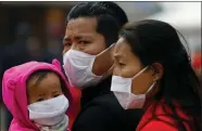  ?? People wearing face masks amid concerns about the spread of coronaviru­s outbreak are pictured at the premises of Boudhanath Stupa in Kathmandu, Nepal on Saturday. REUTERS ??