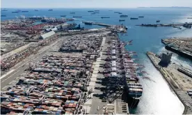  ?? October. Photograph: VCG/Getty Images ?? Containers wait to be loaded at the Long Beach port as cargo ships sit idle in the distance on 16