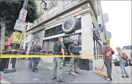  ?? Irfan Khan Los Angeles Times ?? POLICE detained more than 60 people living in the former iO West theater on Hollywood Boulevard. The building was illegally wired and filthy, authoritie­s said.