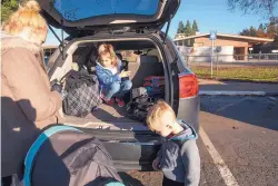  ?? NOAH BERGER/ASSOCIATED PRESS ?? Bella Maloney, 8 arrives Monday in Durham, Calif., for her first day of school since the Camp Fire leveled her family’s home.