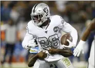  ?? D. ROSS CAMERON — THE ASSOCIATED PRESS ?? Raiders running back Josh Jacobs tries to get away from Chargers defensive end Melvin Ingram III during the first half Nov. 7 in Oakland, Calif.