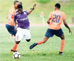  ?? RICARDO MAKYN/MULTIMEDIA PHOTO EDITOR ?? Kingston College’s Renato Campbell (centre) is fouled by Dunoon Technical players Shacqueil Campbell (left) and Leeshawn Edwards during an ISSA/Digicel Manning Cup encounter at the Stadium East field on Monday, September 10.