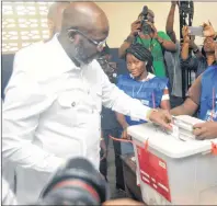  ?? AP PHOTO ?? Former soccer star George Weah, Presidenti­al candidate for the Coalition for Democratic Change, casts his vote during a Presidenti­al runoff election in Monrovia, Liberia on Tuesday. Young Liberians went straight from allnight Christmas celebratio­ns to...