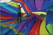  ?? PETE BANNAN — DIGITAL FIRST MEDIA ?? Blair Beard from Air Ventures holds up a balloon as it is inflated during the 12th Annual Chester County Balloon Festival.