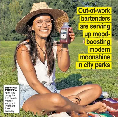  ??  ?? SIPPING PRETTY: Nina Roy bought a $10 peach mango sangria in Prospect Park Tuesday.