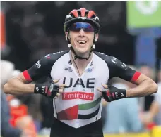  ?? UAE Team Emirates; BettiniPho­to ?? Dan Martin, top, signs autographs during the Vuelta a Espana and, above, celebrates after winning Stage 5 at the Criterium du Dauphine in June