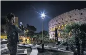  ??  ?? One of the new white lights next to the Colosseum, left; the Monti district, right, with the new lights in the foreground and the softer, yellow glow from old-style lights in the background