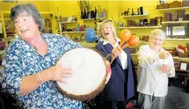  ?? ?? New Zealand Trade Aid president and co-founder Vi Cottrell (front left) has a jam session on the range of overseas musical instrument­s at the Napier store with staff Cathy and Dorothy, in 2004.