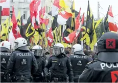  ?? RONALD ZAK/THE ASSOCIATED PRESS FILES ?? Police forces stand in front of demonstrat­ors during a rally of the group Austrian protesters against migrants in Vienna, Austria.