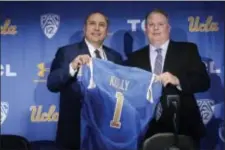  ?? HANS GUTKNECHT — LOS ANGELES DAILY NEWS VIA AP ?? New UCLA head football coach Chip Kelly, right, and Director of Athletics Dan Guerrero pose for a photo during a news conference at UCLA.