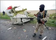  ?? Reuters file ?? A pro-Russian separatist stands at the crash site of Malaysia Airlines flight MH17, near the village of Hrabove (Grabovo) in Donetsk region, Ukraine. —