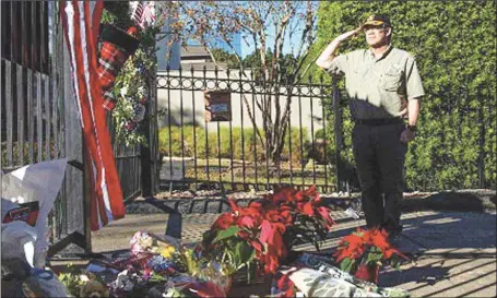  ??  ?? Streven Grimes who served in the Gulf war from 1990- 1991 and served in the military from 1975 to 2007 salutes, in tribute to former US President George H. W. Bush, at the makeshift memorial formed outside the home of President George H.W. Bush in Houston, Texas… yesterday