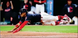  ?? ASSOCIATED PRESS ?? CLEVELAND INDIANS’ FRANCISCO LINDOR scores on a sacrifice fly by Jose Ramirez against the Detroit Tigers during the second inning of Monday’s game in Cleveland.