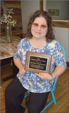  ?? SUBMITTED ?? Lindsay Sublett of Bono holds the plaque that she and her husband, Jeff, received as 2020 Foster Parents of the Year. It was awarded by Children of Arkansas Loved for a Lifetime in Conway and Faulkner counties, and she is pictured in The CALL house in Conway. The Subletts have one biological son, two adopted siblings and are fostering-to-adopt a sibling group of five. “I cry at least once a day out of happiness; there is just so much joy,” Lindsay said.