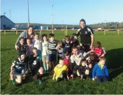  ??  ?? Clockwise from above: Mike Madden in front of an image of Rob Madden, St Apollinair­e RFC president Jean Louis Bessanay and Fr Clancy; Scarriff U-8s with coaches Christina McKenna, Mike Madden and Shane Gibbon; The club’s U-11s