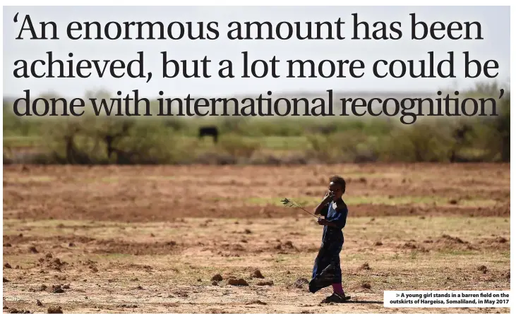  ??  ?? > A young girl stands in a barren field on the outskirts of Hargeisa, Somaliland, in May 2017