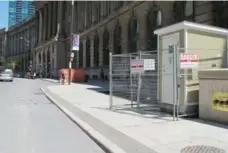  ?? JACK LAKEY/TORONTO STAR ?? Barriers on Front St. appear to protect a portable toilet and a garbage pile.