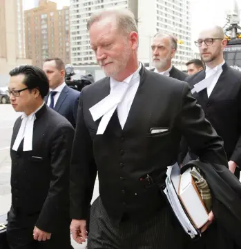  ?? CHRIS HELGREN / REUTERS ?? Crown prosecutor Michael Cantlon leaves court in Toronto Friday after serial killer Bruce McArthur was sentenced to life imprisonme­nt. McArthur had previously pleaded guilty to eight counts of first-degree murder.