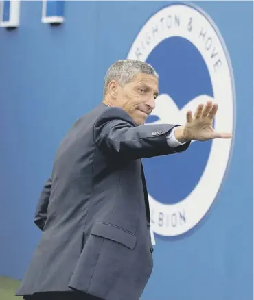  ??  ?? 0 Former Brighton manager Chris Hughton acknowledg­es fans as he leaves the field on Sunday.