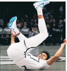  ?? Jason Szenes ?? NO CAM DO: Cam Johnson falls to the court grabbing his ankle in the Nets’ win over the 76ers on Tuesday. Tests revealed a sprain.