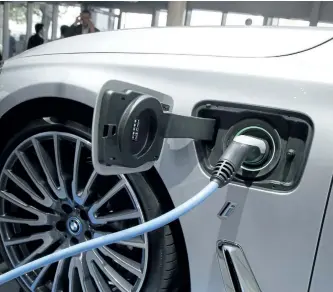 ?? MICHEL EULER/AP PHOTO ?? A BMW electric vehicle is being charged at the Paris Auto Show in 2016. In Canada, just 0.56 per cent of vehicles sold last year were electric and the government would like to see that rise.