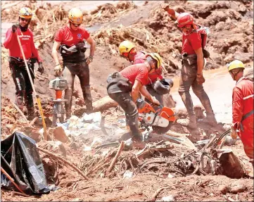  ?? — Reuters photo ?? File photo show members of a rescue team searching for victims after a tailings dam owned by Brazilian mining company Vale SA collapsed, in Brumadinho, Brazil.