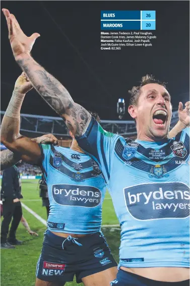 ??  ?? Mitchell Pearce celebrates with his NSW teammates after finally breaking his Origin series hoodoo.