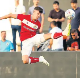  ??  ?? Bristol City’s Rory Holden stretches out a leg to bring the ball under control