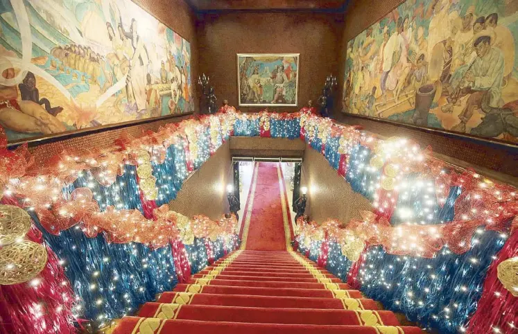  ?? STAR photos by KRIZJOHN ROSALES ?? The staircase is decked in raffia, rattan balls, and lights, echoing the colors of the paintings by National Artist Botong Francisco. On the Cover: The Christmas tree in the upstairs Reception Hall is a sight to behold, made up of over 400 potted bromeliads.