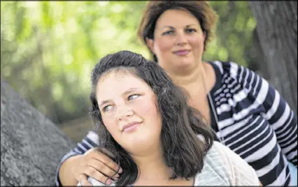  ?? AP ?? Kaley Zacher poses for a portrait with her mother, Kimberly, in Dublin. Kaley’s mother gave permission for Kaley to be paddled twice at Southwest Laurents Elementary School. Although the use of corporal punishment in American schools has declined in...