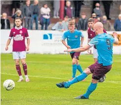  ??  ?? Liam Boyce scores Hearts’ fourth from the spot.