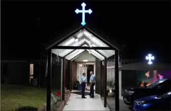  ?? Mark Baker/Associated Press ?? Security officers stand guard Monday outside Orthodox Assyrian church in Sydney. Police said a 16-year-old was arrested after a bishop and a priest were stabbed in the Australian church. There are no life-threatenin­g injuries.