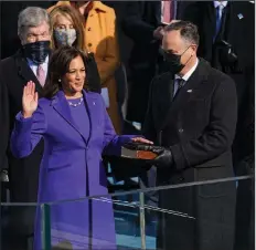  ?? (Erin Schaff/The New York Times via AP, Pool) ?? Kamala Harris is sworn in as vice president by Supreme Court Justice Sonia Sotomayor as her husband, Doug Emhoff, holds the Bible during the 59th Presidenti­al Inaugurati­on at the U.S. Capitol in Washington on Jan. 20.