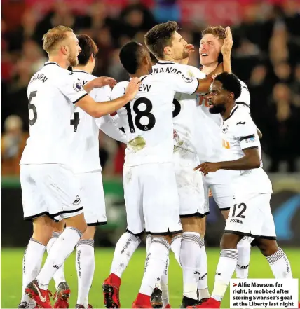  ??  ?? > Alfie Mawson, far right, is mobbed after scoring Swansea’s goal at the Liberty last night