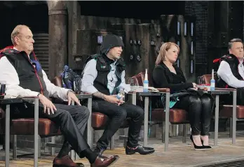  ??  ?? TV’s Dragons’ Den panelists wear the Snug Vest created by a Vancouver entreprene­ur to help the autistic.