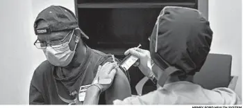  ?? HENRY FORD HEALTH SYSTEM ?? A federal office with expertise in vaccine safety was disbanded in 2019. Above, a volunteer gets a shot as part of a coronaviru­s vaccine trial in August.