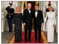  ?? (AP/Patrick Semansky) ?? President Joe Biden and first lady Jill Biden (left) greet French President Emmanuel Macron and his wife, Brigitte, as they arrive Thursday evening for a State Dinner on the North Portico of the White House.