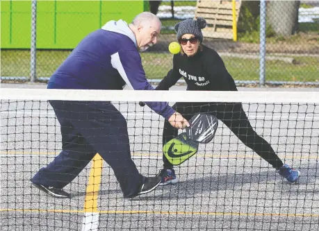  ?? NICK BRANCACCIO ?? Silvio Civitarese hits a backhand during a pickle ball game with playing partner Joanne Laforest in East Riverside on Thursday.