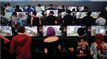  ??  ?? Gamers play video games during the opening of the world’s largest computer games fair Gamescom in Cologne, Germany. — Reuters photo