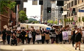  ?? Lucy Schaly/Post-Gazette ?? Participan­ts in a peaceful march for the Black Lives Matter movement make their way along the Boulevard of the Allies in downtown Pittsburgh on June 13.