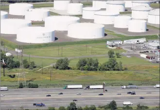  ?? Mark Lennihan / Associated Press ?? In this Sept. 8, 2008 file photo traffic on Interstate 95 passes oil storage tanks owned by the Colonial Pipeline Company in Linden, N.J. A major pipeline that transports fuels along the East Coast says it had to stop operations because it was the victim of a cyberattac­k. Colonial Pipeline said in a statement late Friday that it “took certain systems offline to contain the threat, which has temporaril­y halted all pipeline operations, and affected some of our IT systems.”