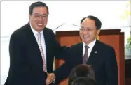  ??  ?? Wang Zhimin (right), central government liaison chief in Hong Kong, shakes hands with Legislativ­e Council President Andrew Leung Kwan-yuen.