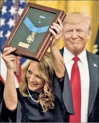  ??  ?? ‘FIGHT ON’: Valerie Nessel, widow of Air Force Technical Sgt. John Chapman (inset), with the medal of Honor awarded to her husband by President Trump Wednesday.