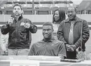  ?? [PHOTO BY NATE BILLINGS, THE OKLAHOMAN] ?? Edmond North’s Daryl Dike, middle, listens to Edmond North soccer coach Chris Waugh, left, talk about him with his parents, Jessy Dike and Vincent Dike, on National Signing Day.