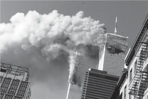  ?? RICHARD DREW/AP ?? Smoke rises from the burning twin towers of the World Trade Center after hijacked planes crashed into them on Sept. 11, 2001, in New York City.