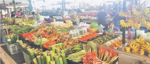  ??  ?? Jungle fruits, vegetables and farm produce from Sarawak’s interior areas are available at the Bandar Riyal market.