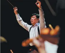  ?? PHOTOS PROVIDED TO AND BY JIANG DONG / CHINA DAILY ?? Top: Carmen by the Opera Comique will be a highlight of the Beijing Music Festival’s program. Above: Yu Long, chairman of Beijing Music Festival, says the music must go on to give people courage.