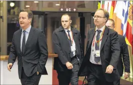  ?? GEERT VANDEN WIJNGAERT / ASSOCIATED PRESS 2016 ?? Then British Prime Minister David Cameron (left) leaves an EU summit in Brussels in February with Ivan Rogers, Britain’s representa­tive to the European Union (right). Cameron resigned after failing to convince Britons to reject the June referendum on...