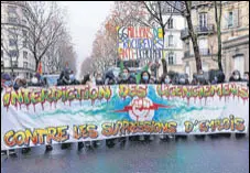  ?? AFP ?? Demonstrat­ors march holding a banner that reads in French, 'Ban on layoffs against job cuts' during a rally in Paris.