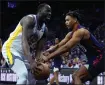  ?? MATT SLOCUM — THE ASSOCIATED PRESS ?? Golden State Warriors forward Draymond Green, left, tries to hang onto the ball against Philadelph­ia’s Jaden Springer during the first half of Wednesday’s game in Philadelph­ia.